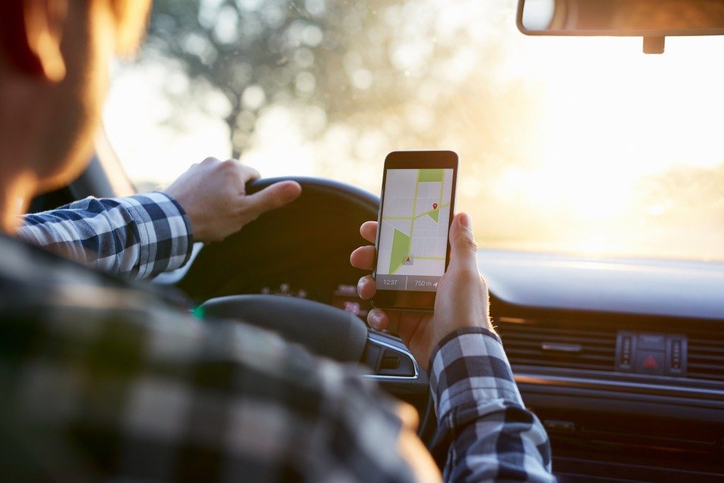 Man using GPS on mobile while driving