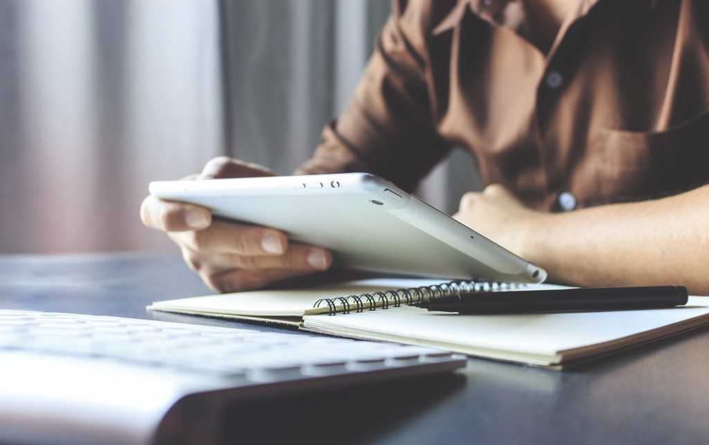 Man using a silver tablet