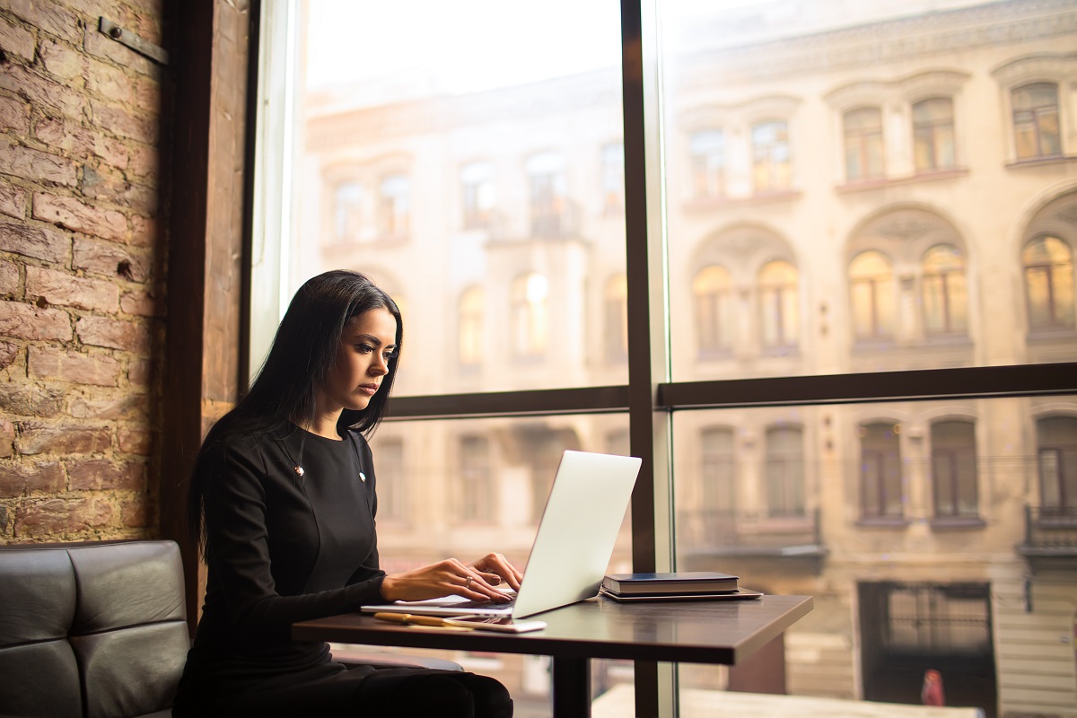 woman using laptop in coffee shop