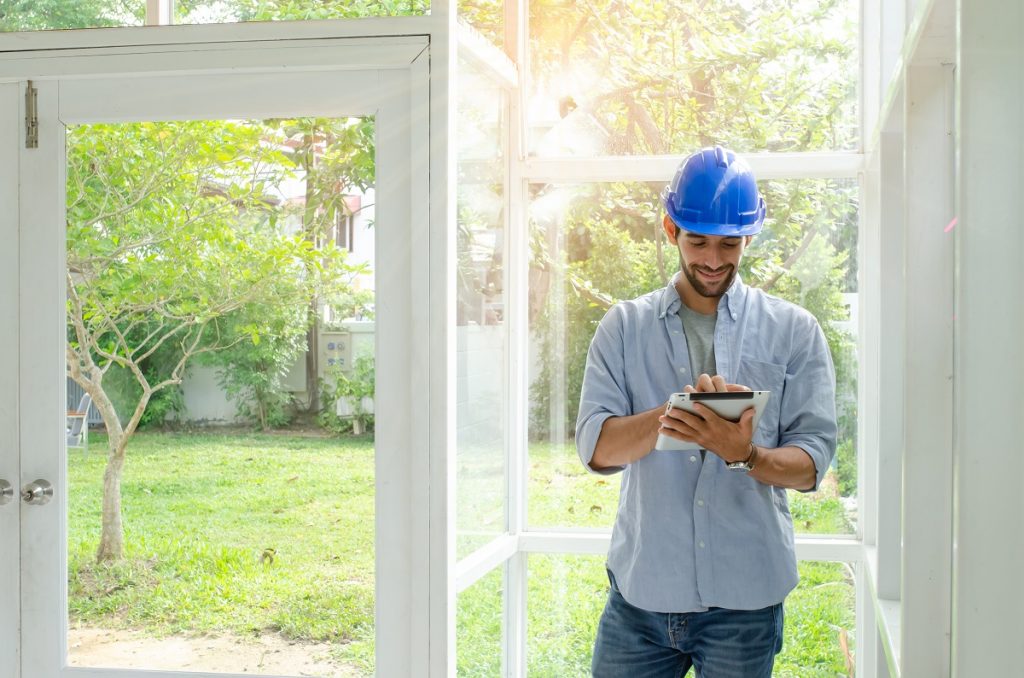 engineer taking house measurements