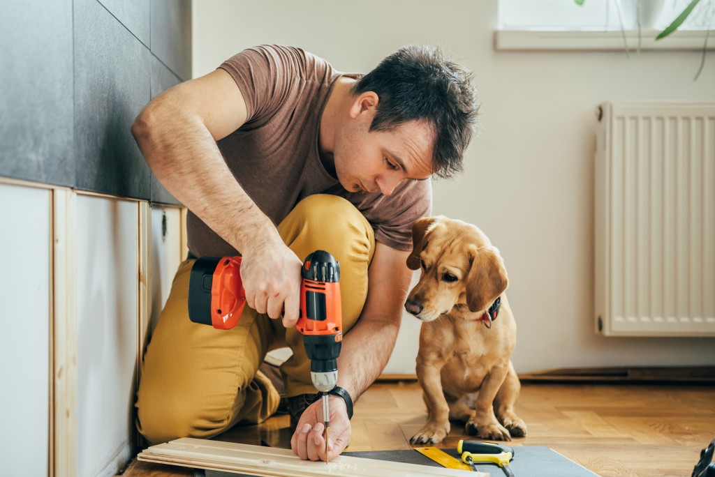 man with his dog doing construction work