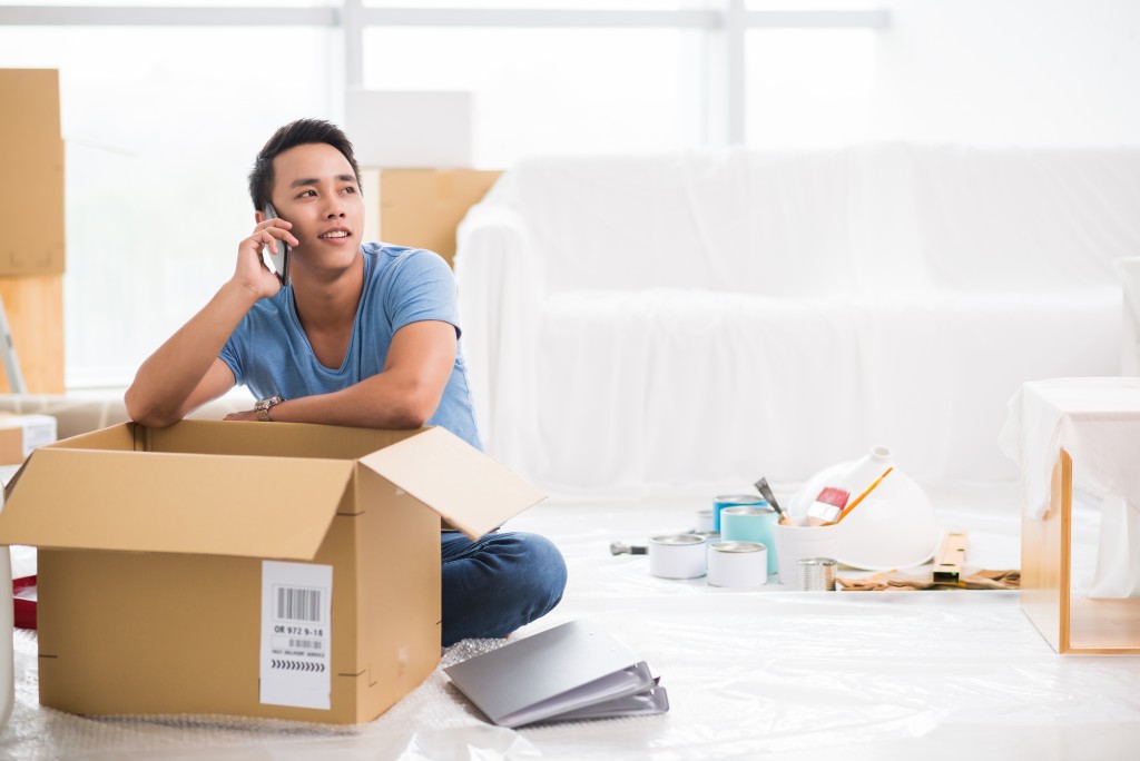 Man talking on the phone while packing