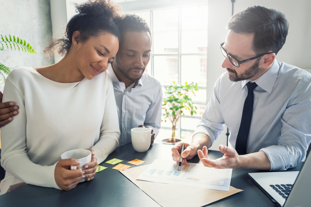 Couple talking to broker