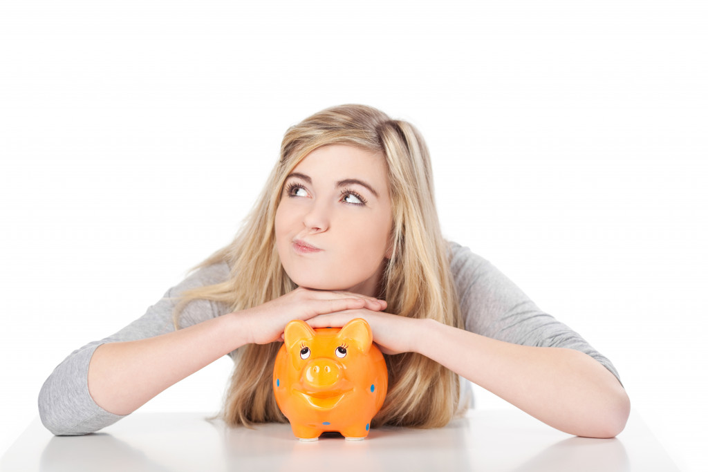 Girl posing with piggy bank