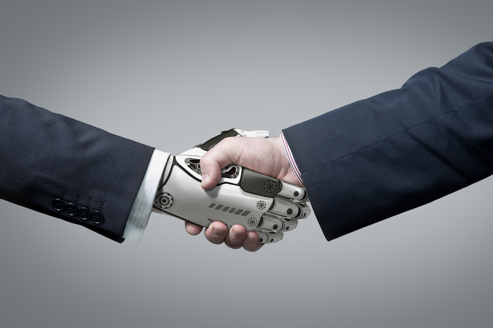 Hand shake of robot and businessman