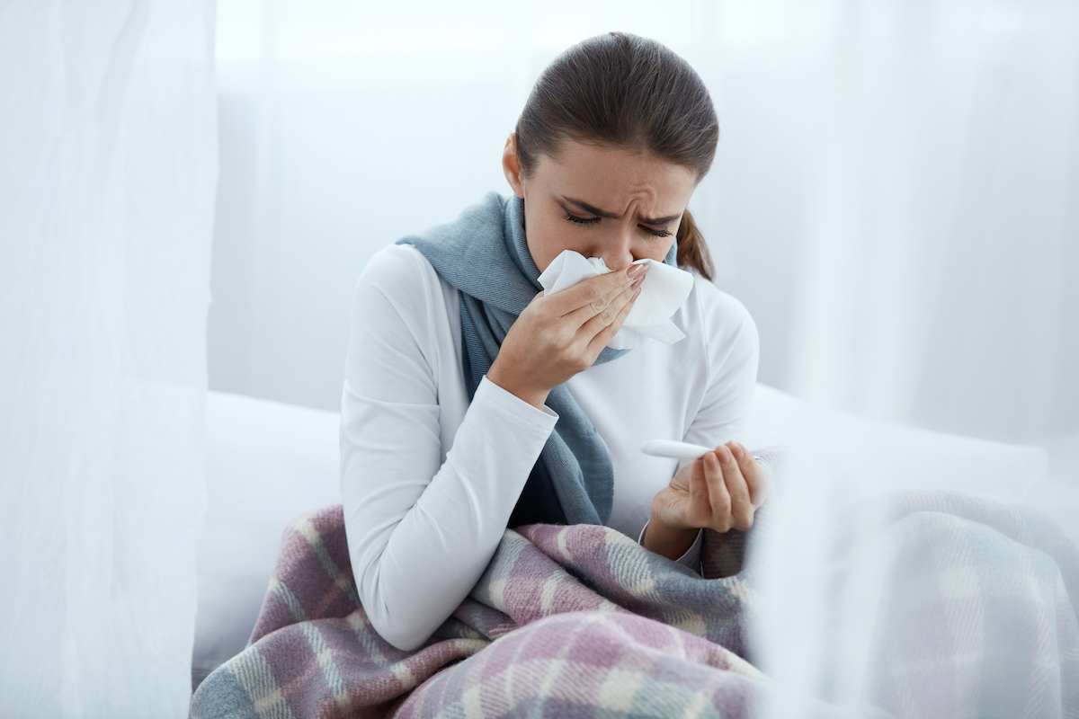 woman feeling sick at home