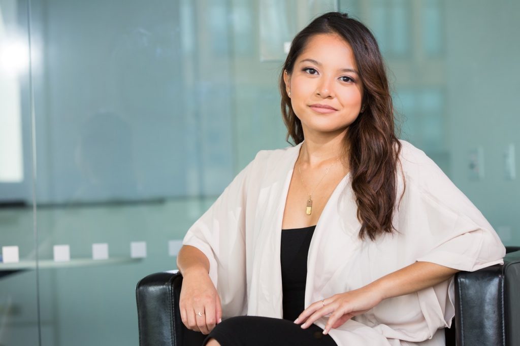 woman wearing corporate attire sitting on a chair