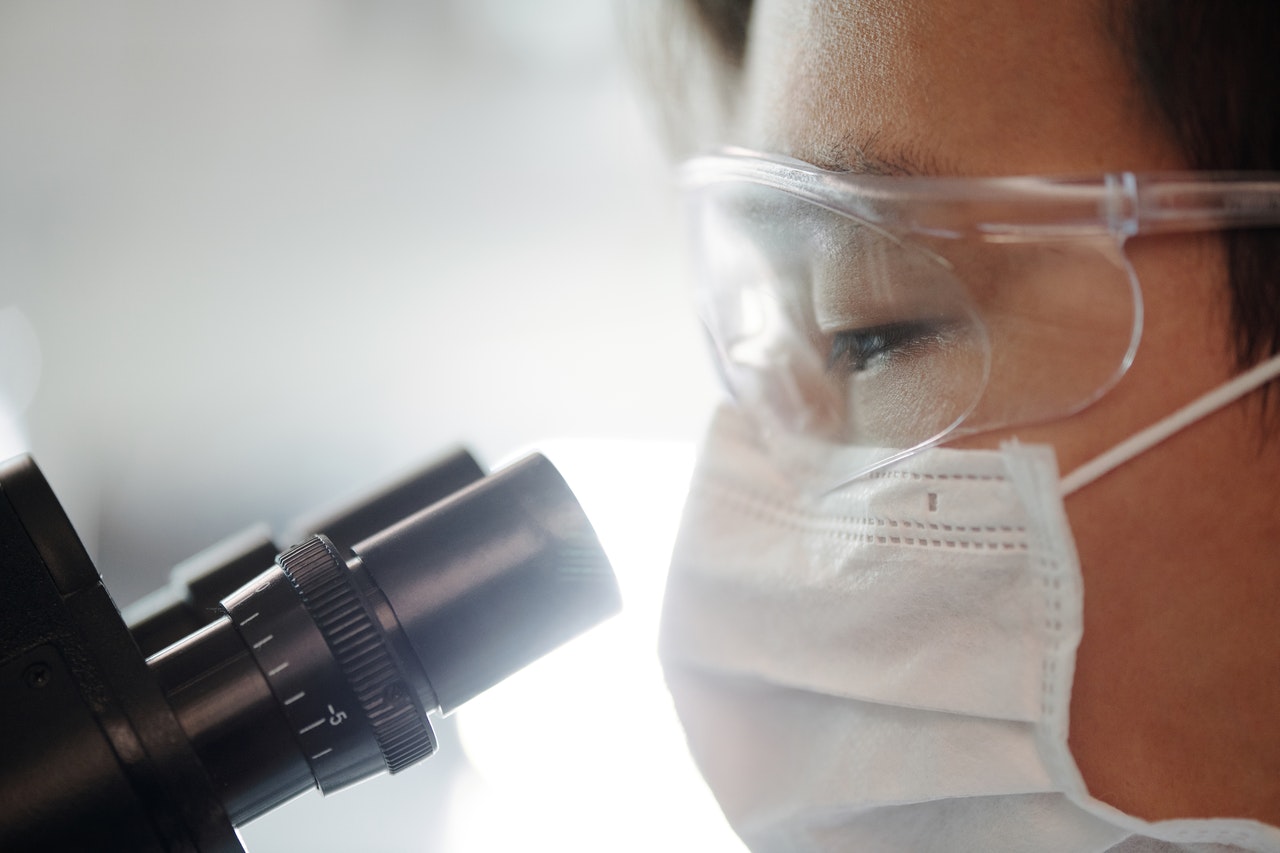 person looking through a microscope