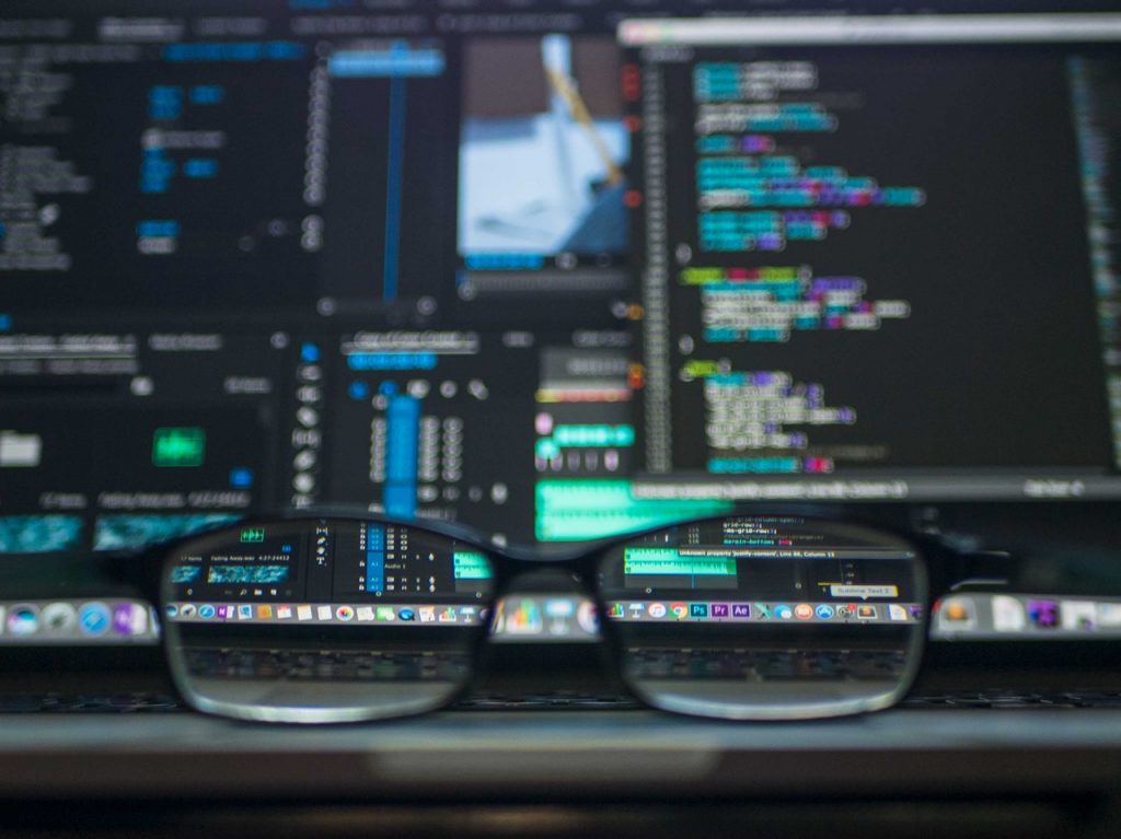 a pair of glasses in front of a computer