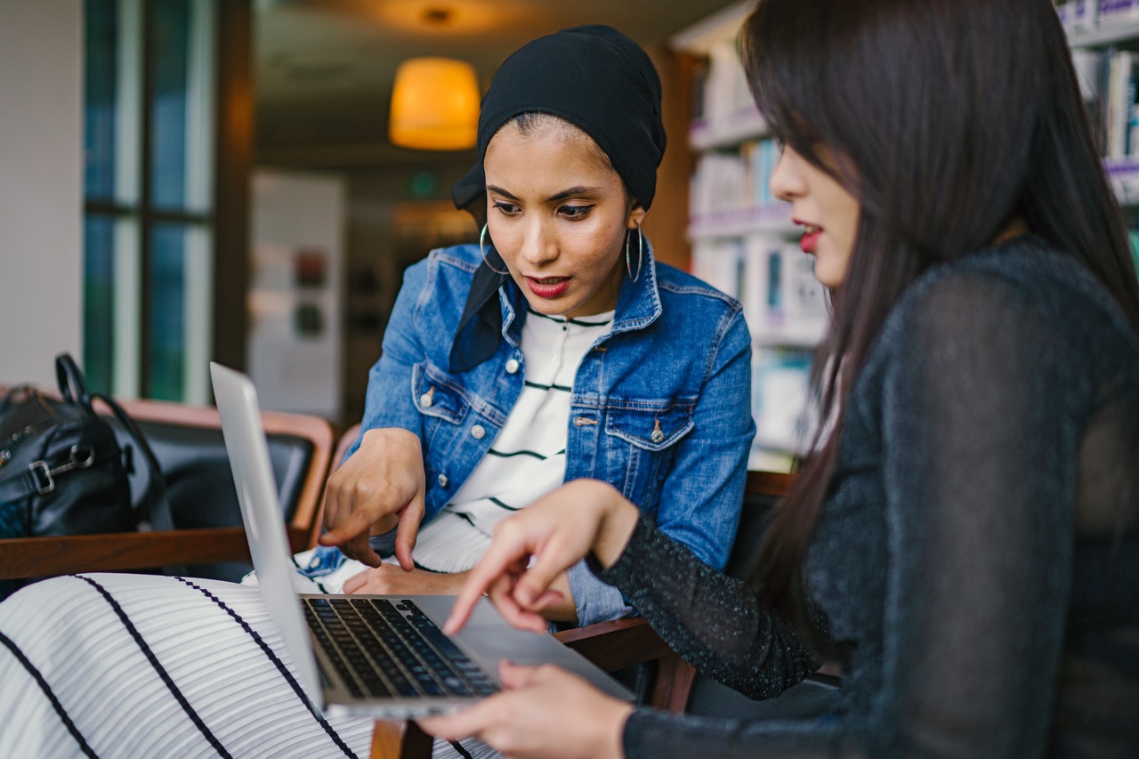 two women looking at a laptop