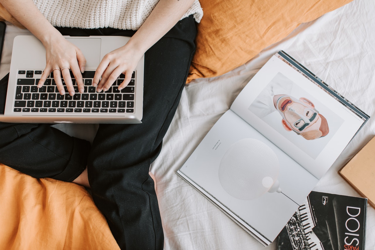 person on their laptop next to some illustrations