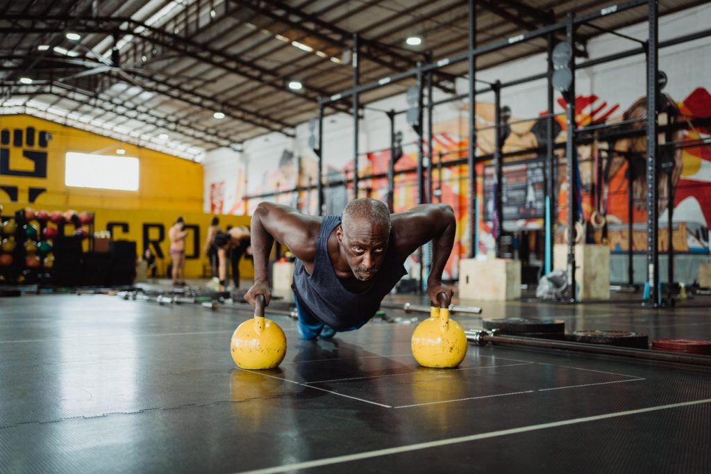 man doing pushups on medicine balls